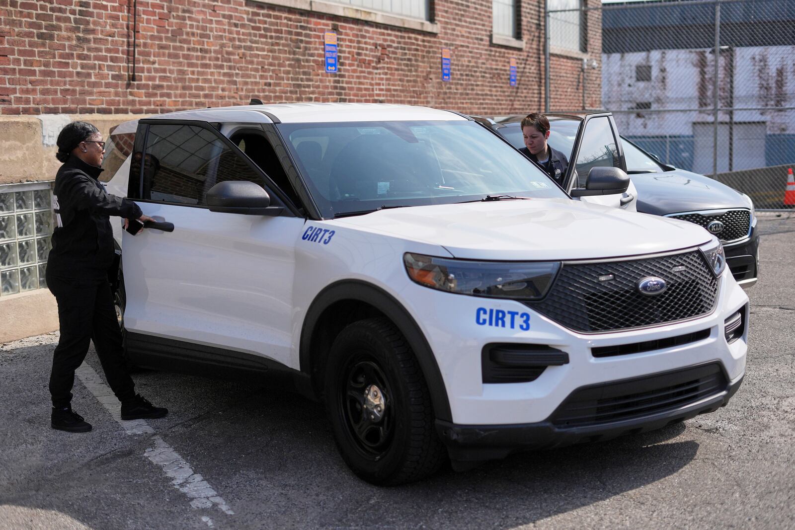 Crisis Intervention Response Team (CIRT) members Therapist Krystian Gardner, left, and Philadelphia Police Officer Vanity Cordero prepare to go out on calls in Philadelphia, Friday, March 14, 2025. (AP Photo/Matt Rourke)