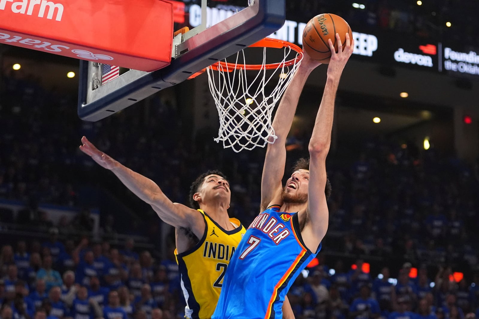 Oklahoma City Thunder forward Chet Holmgren (7) dunks against Indiana Pacers guard Ben Sheppard (26) during the first half of Game 2 of the NBA Finals basketball series Sunday, June 8, 2025, in Oklahoma City. (AP Photo/Julio Cortez)