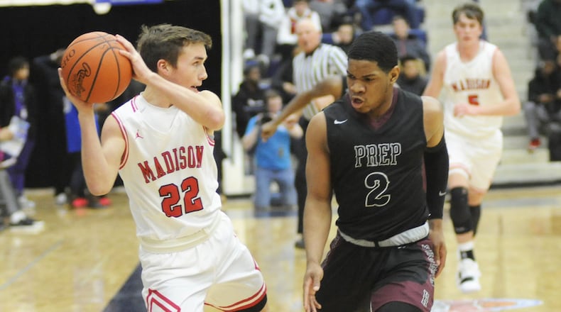Madison’s Jake Phelps (22) is confronted by Christopher Anthony of Canal Winchester Harvest Prep on Monday night during Flyin’ to the Hoop at Fairmont’s Trent Arena. Harvest Prep won 79-56. MARC PENDLETON/STAFF