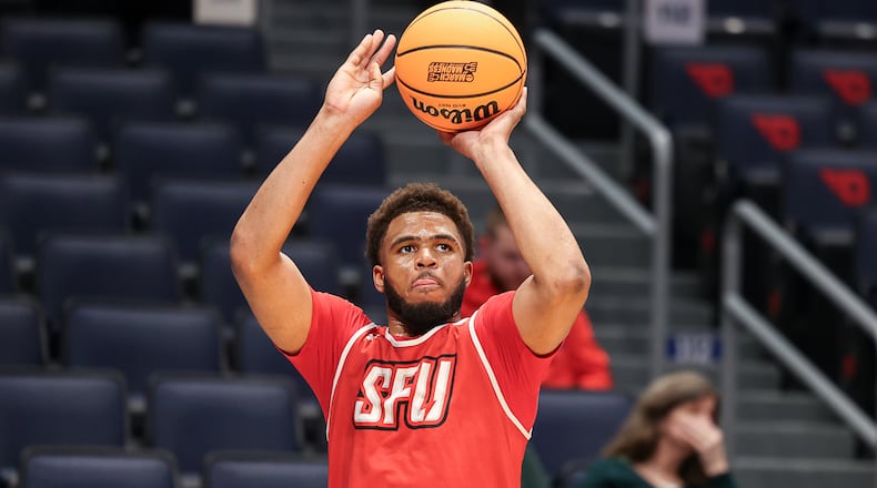 St. Francis University freshman guard Juan Cranford Jr. shoots a 3-pointer during a First Four practice on Monday at University of Dayton Arena. Cranford is a Wayne graduate and was named Northeast Conference rookie of the year. Cranford averages 10 points and 4.1 rebounds per game. He was named Greater Western Ohio Conference player of the year in his senior season for Wayne and surpassed 1,000 career points. BRYANT BILLING / STAFF