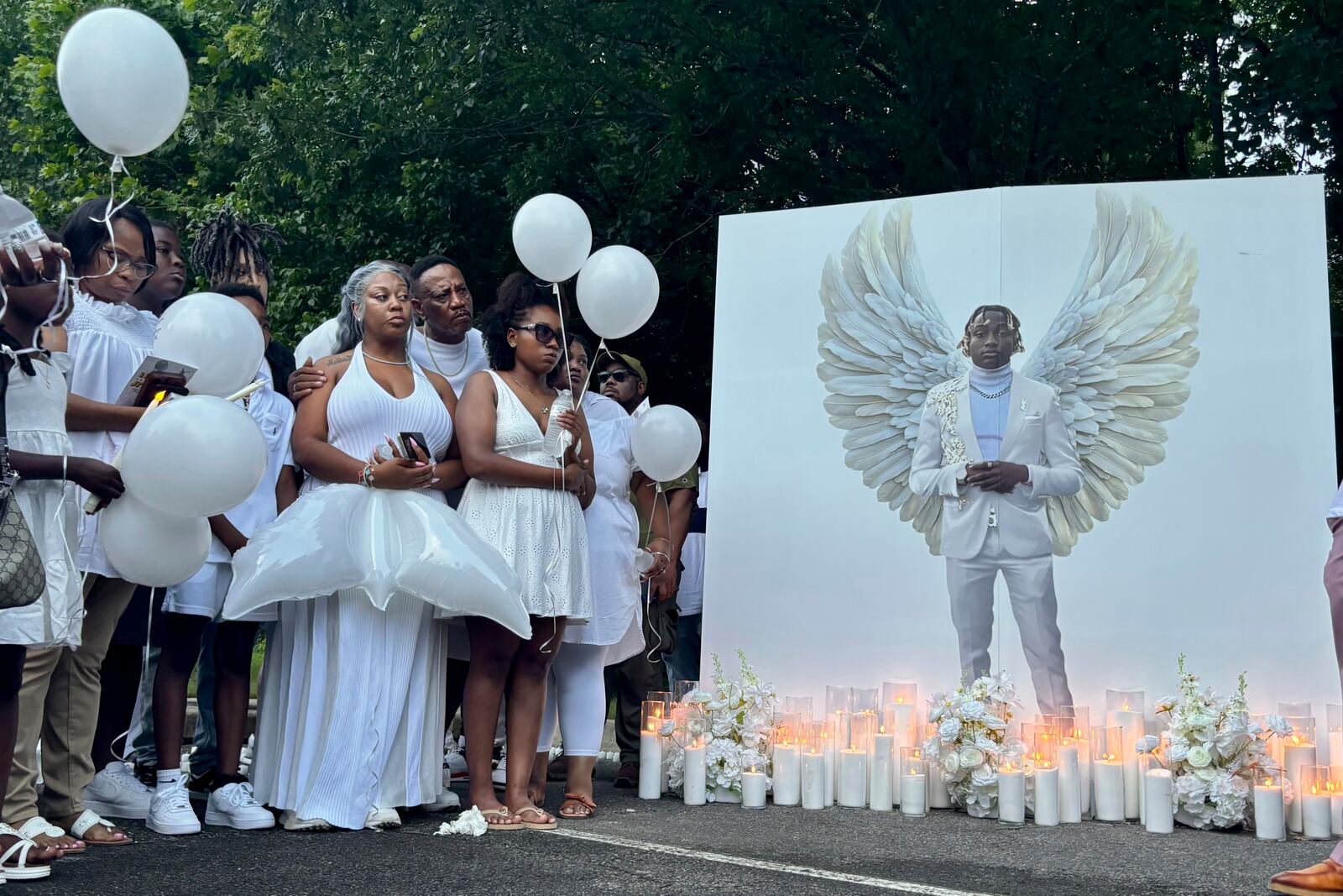 Family members of Jabari Peoples hold balloons at a candlelight vigil in Homewood, Ala., Monday, June 30, 2025. Peoples, 18, was shot and killed by police at the spot at a Homewood soccer field complex on Monday, June 23. (AP Photo/Kim Chandler)