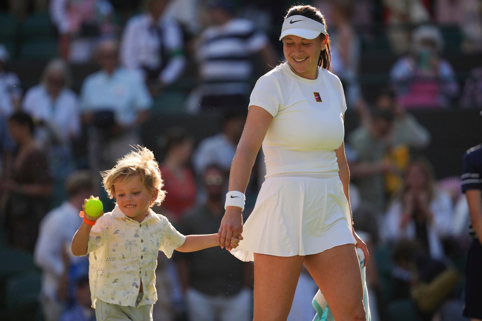 Amanda Anisimova of the U.S. celebrates with her nephew Jackson winning the women's singles quarter finals match against Anastasia Pavlyuchenkova of Russia at the Wimbledon Tennis Championships in London, Tuesday, July 8, 2025.(AP Photo/Kin Cheung)