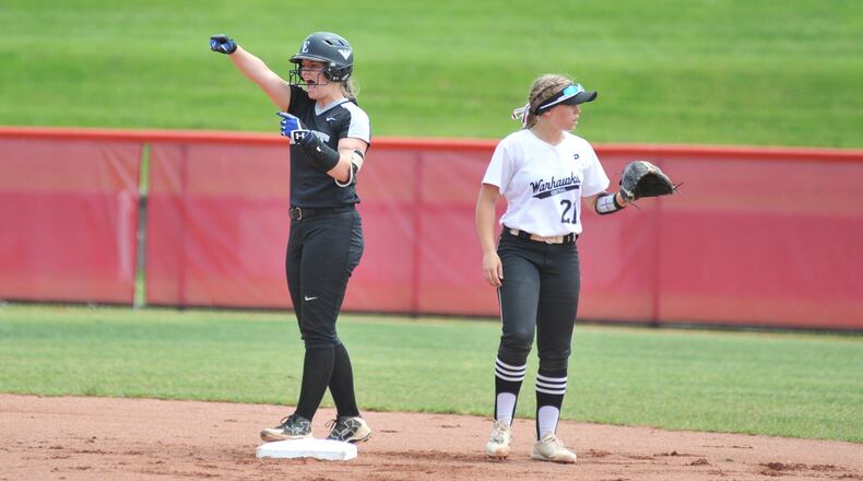 Lakota East’s Cassidy Hudson points to her dugout Friday after smacking a double against Westerville Central in a Division I state softball semifinal at Firestone Stadium in Akron. That’s the Warhawks’ Emily O’Dee (21) waiting for the ball. East advanced to the state final with a 4-3 win. RICK CASSANO/STAFF