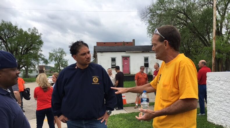 UAW Local 14 member Tony Totti, left, listens as Fuyao worker Larry Yates speaks with him at the UAW rally held in Dayton April 30. THOMAS GNAU/STAFF
