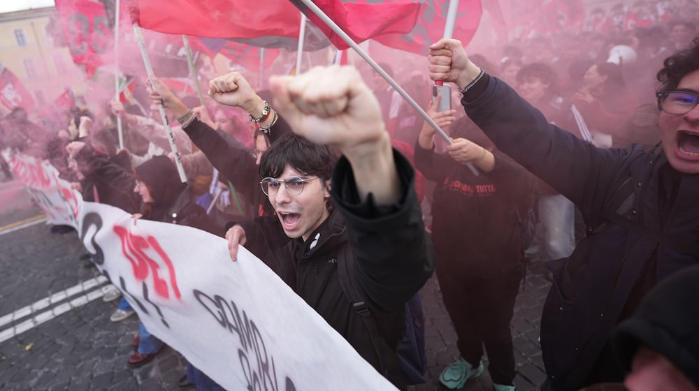 People take part in a national demonstration against the war in Iran and the March 22 referendum on the Italian justice system, in Rome, Saturday, March 14, 2026. (AP Photo/Andrew Medichini)