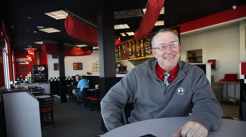 In this 2014 photo, Ray Wiley, founder of Hot Head Burritos and Rapid Fired Pizza, sits inside his Hot Head Burritos store at 1120 E. Stroop Road in Kettering. Wiley is also co-founder of another new restaurant venture, Wiley's Wings, Tenders and Fries. FILE