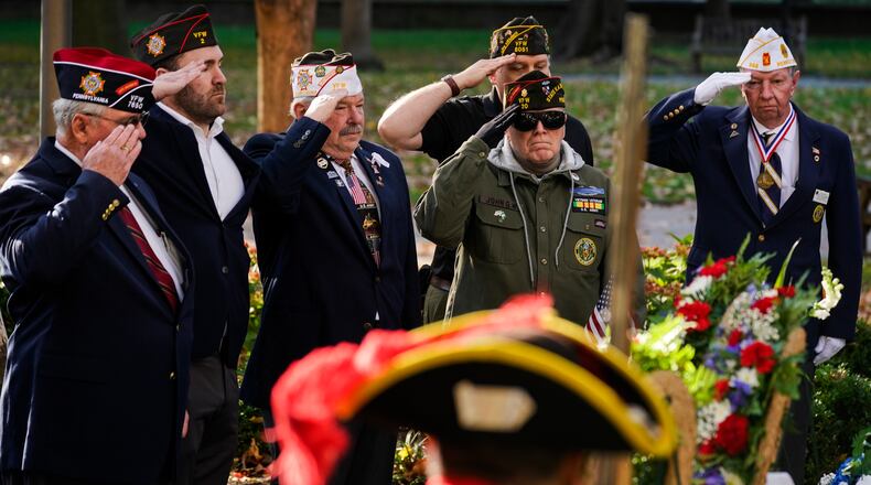 Veterans salute during a Veterans Day commemoration ceremony at the Tomb of the Unknown Revolutionary War Soldier in Philadelphia, Thursday, Nov. 11, 2021. (AP Photo/Matt Rourke)