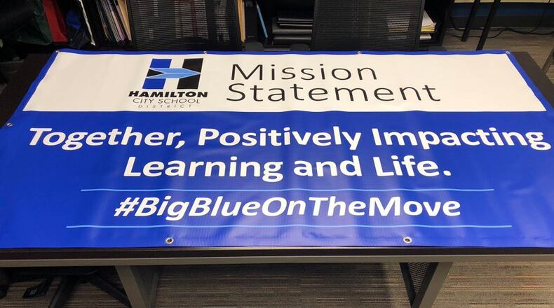 Hamilton Schools officials recently unveiled a new Twitter hashtag - "Big Blue On The Move" - along with a new mission statement as the district looks to bring a sharper marketing edge to its public image. Banners with the new slogan and mission statement will be featured in Hamilton Schools in the coming school year. More area schools are creating and tweaking their social media identifiers and mission statements to better market their districts to the public. (Provided photo/Journal-News)