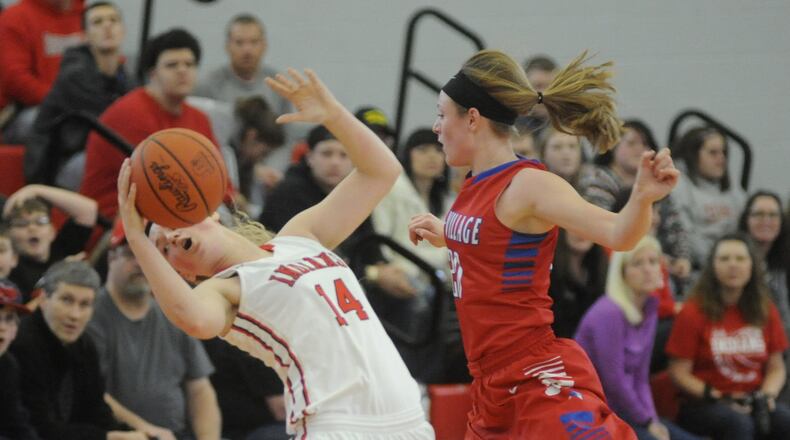 Cedarville’s Ise Bolender (left) is whacked by Allie Downing of Tri-Village. Tri-Village defeated Cedarville 49-42 in a girls high school basketball D-IV district final at Troy on Saturday, March 4, 2017. MARC PENDLETON / STAFF