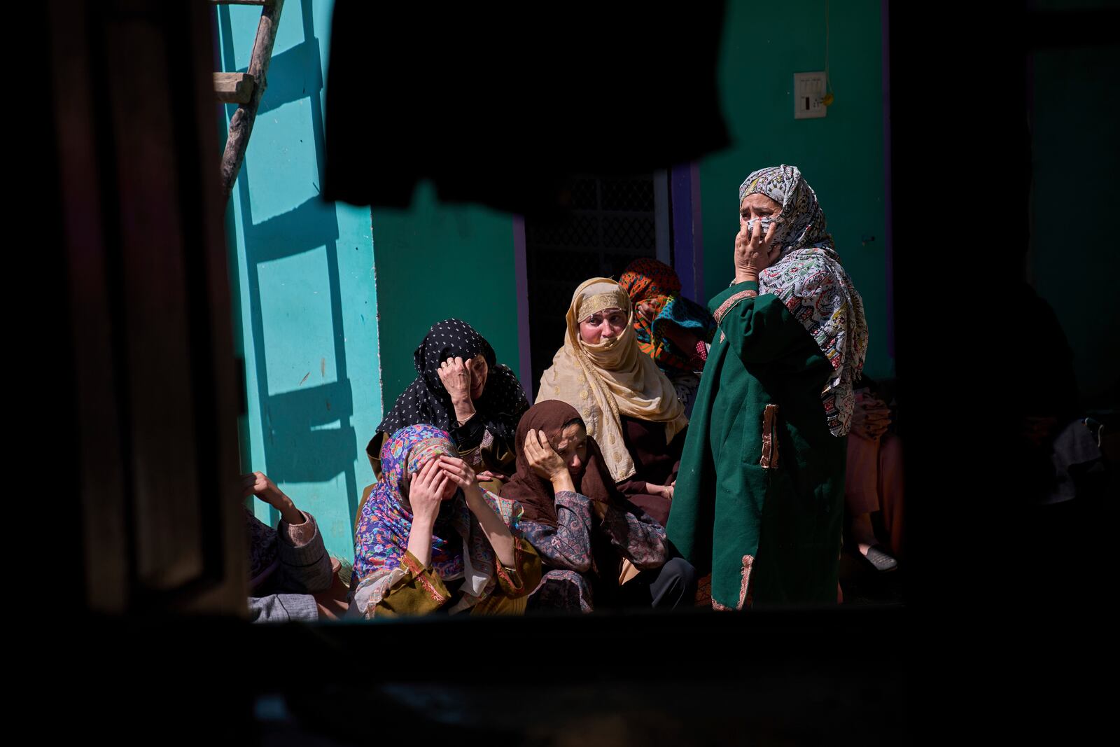 Kashmiri villager women grieve as they sit outside the blown-up family home of Asif Shiekh, a militant who officials say is involved in the deadly attack on tourists in Pahalgam, at Monghama village in Tral, south of Srinagar, Indian controlled Kashmir, Friday, April 25, 2025. (AP Photo/Dar Yasin)