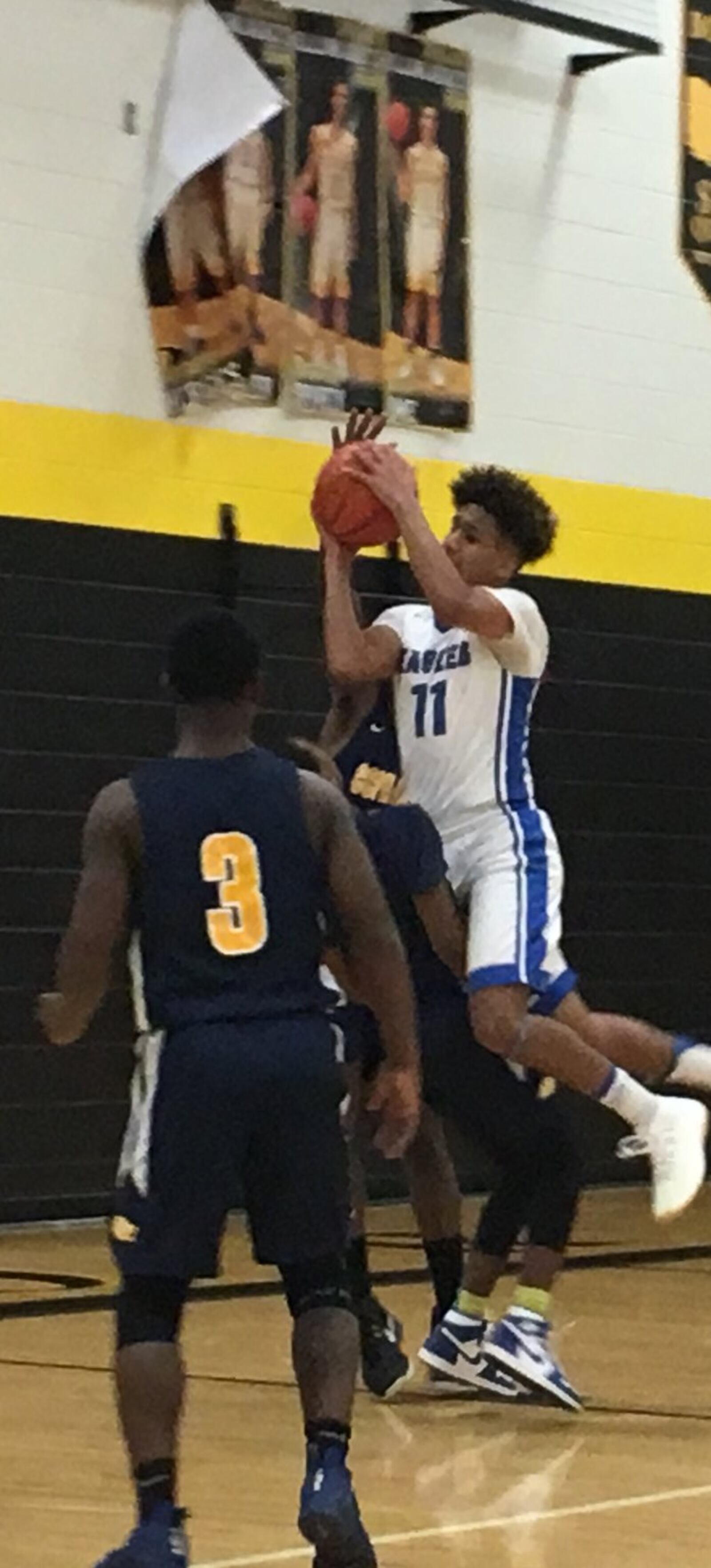 Middletown Christian’s C.J. Money (11) drives into Cincinnati College Prep Academy’s Shamon McDavis (4) as RonJon Patterson (3) watches Saturday night during a Division IV sectional final at Taylor. RICK CASSANO/STAFF