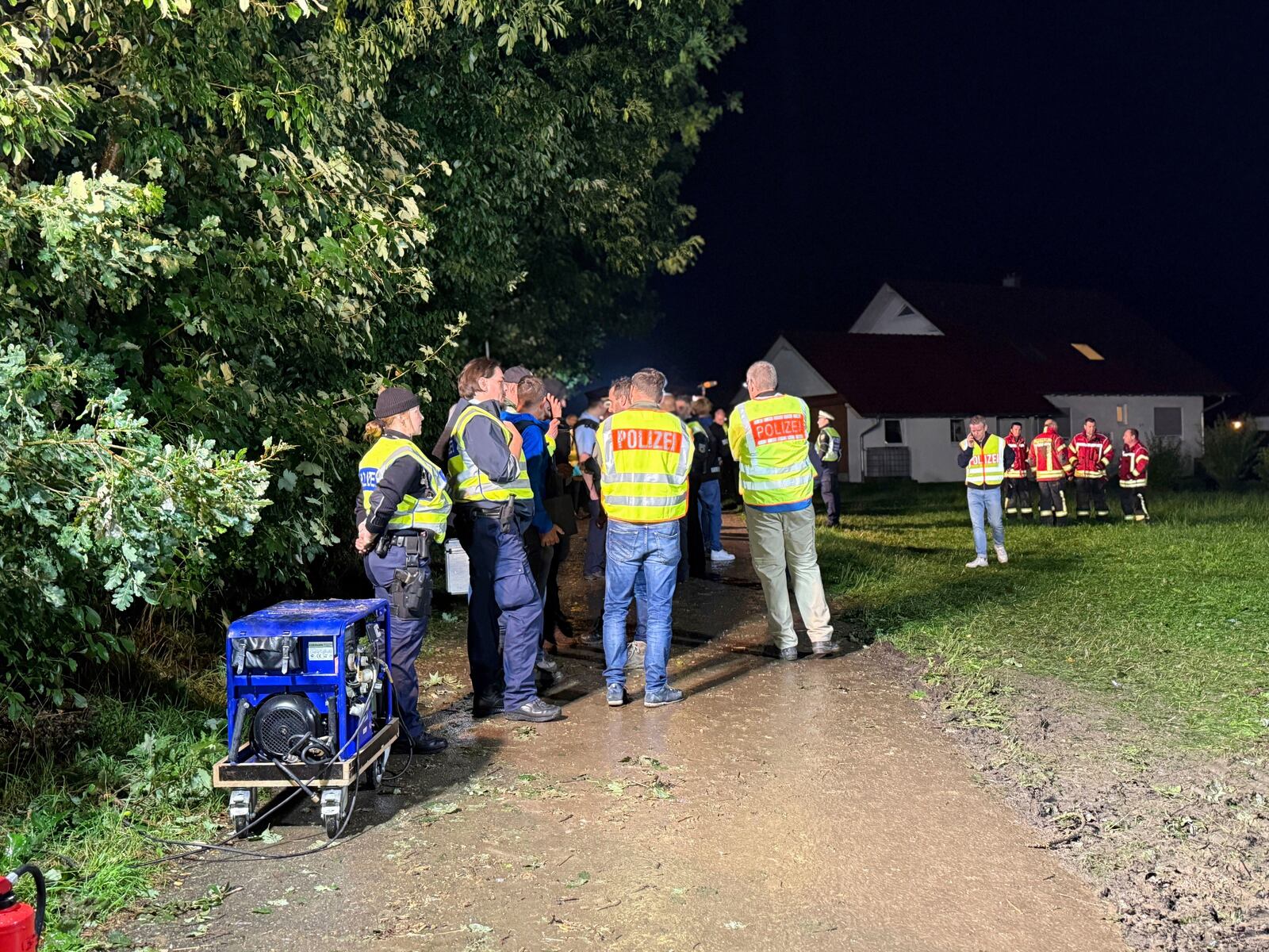 Emergency services stand near the derailed regional passenger train on a section of track near Riedlingen, Germany, Sunday, July 27, 2025. (Nico Pointner/dpa via AP)