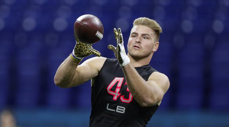FILE - In this Feb. 29, 2020, file photo, Wyoming linebacker Logan Wilson runs a drill at the NFL football scouting combine in Indianapolis. Wilson was selected by the Cincinnati Bengals in the third round of the NFL football draft Friday, April 24, 2020. (AP Photo/Michael Conroy, File)