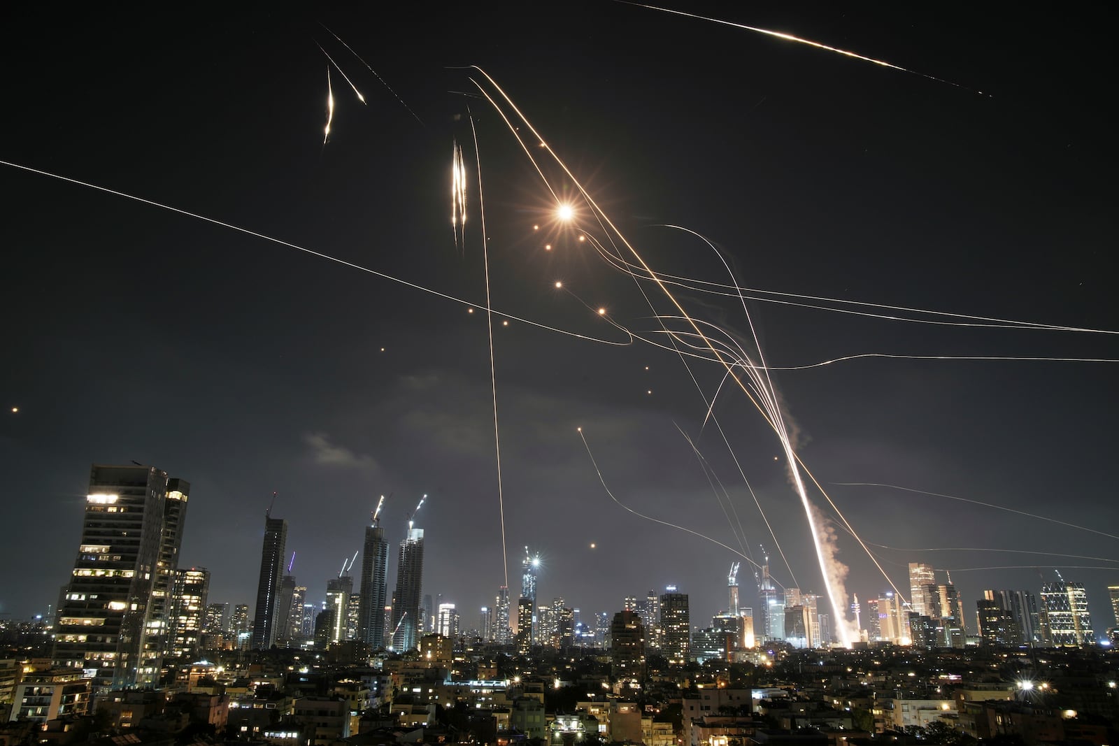FILE - Israeli Iron Dome air defense system fires to intercept missiles over Tel Aviv, Israel, on June 13, 2025. (AP Photo/Leo Correa, File)