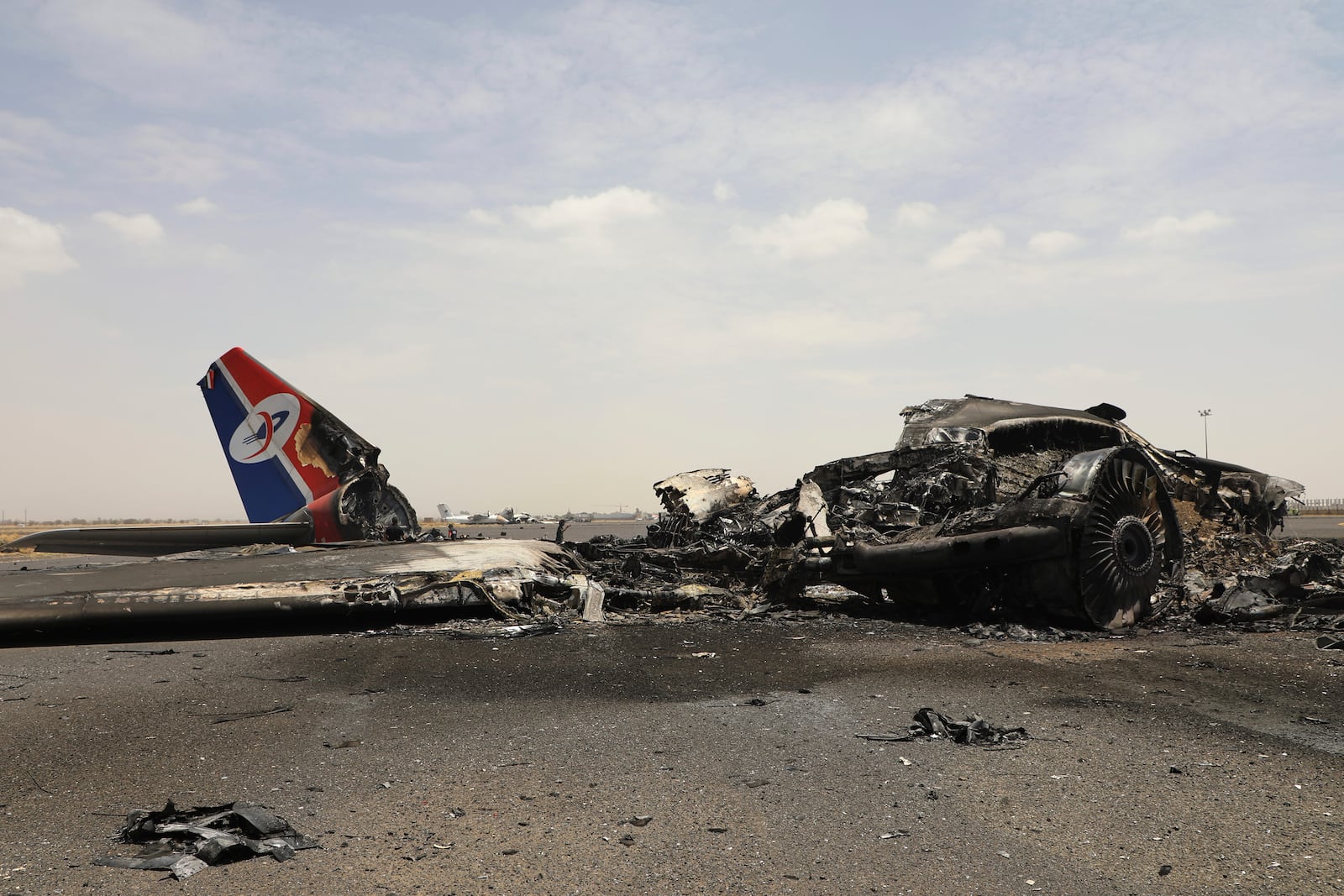 Yemenis inspect wreckage of a destroyed civilian aircraft following Israeli airstrikes on Sanaa International Airport in Sanaa, Yemen, Wednesday, May 7, 2025. (AP Photo/Osamah Abdulrahman)