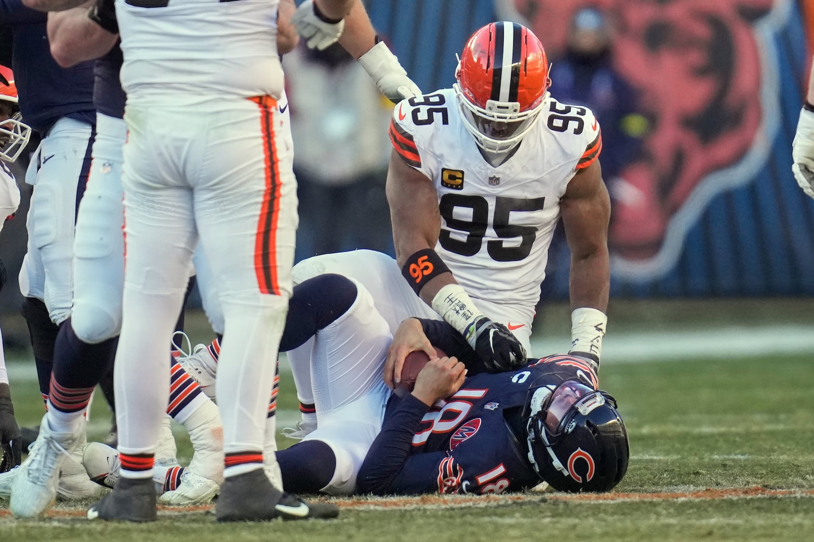 Cleveland Browns defensive end Myles Garrett (95) and Chicago Bears quarterback Caleb Williams (18) after a sack in the second half of an NFL football game in Chicago, Sunday, Dec. 14, 2025. (AP Photo/Erin Hooley)