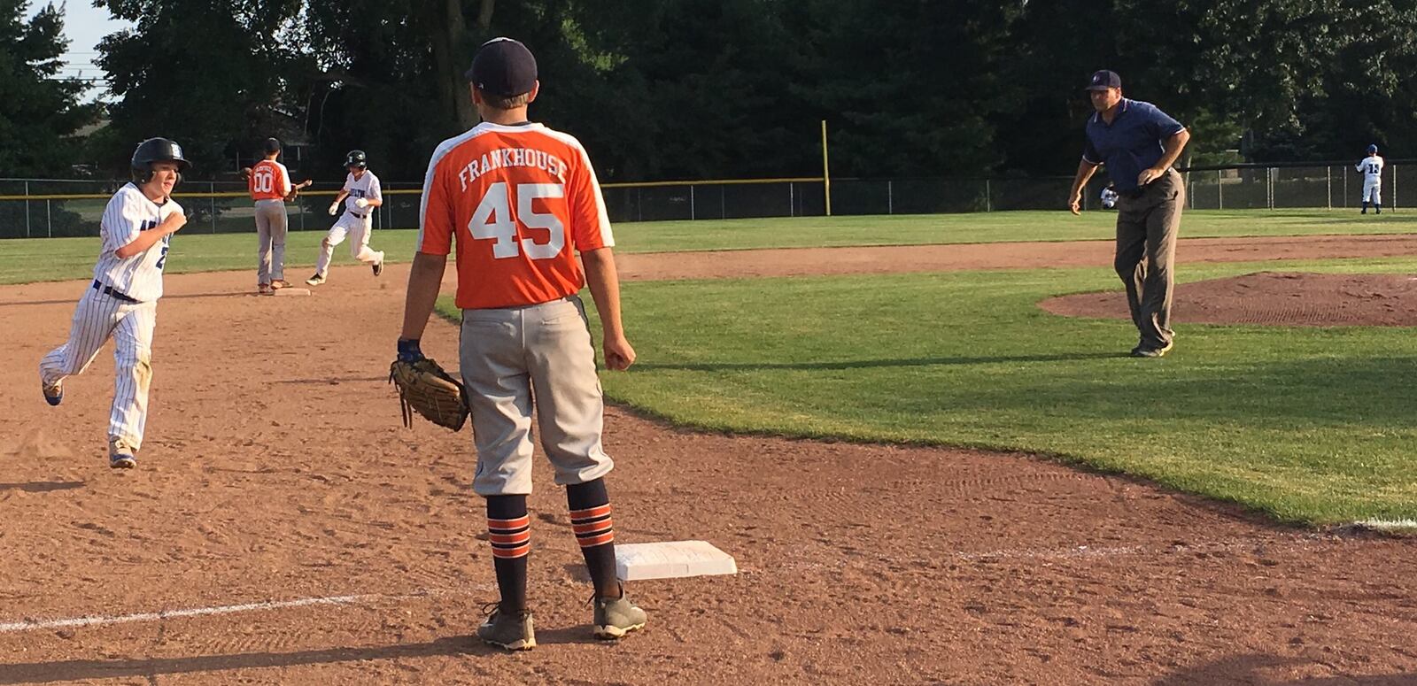 Hamilton West Side’s Jonathan Alcorn heads toward third base as teammate Noah Prewitt rounds second Thursday night in the Ohio Little League Tournament at the Hoover Community Recreation Complex. Hamilton beat Galion 15-1 — that’s Galion’s Carson Frankhouse watching the play. RICK CASSANO/STAFF
