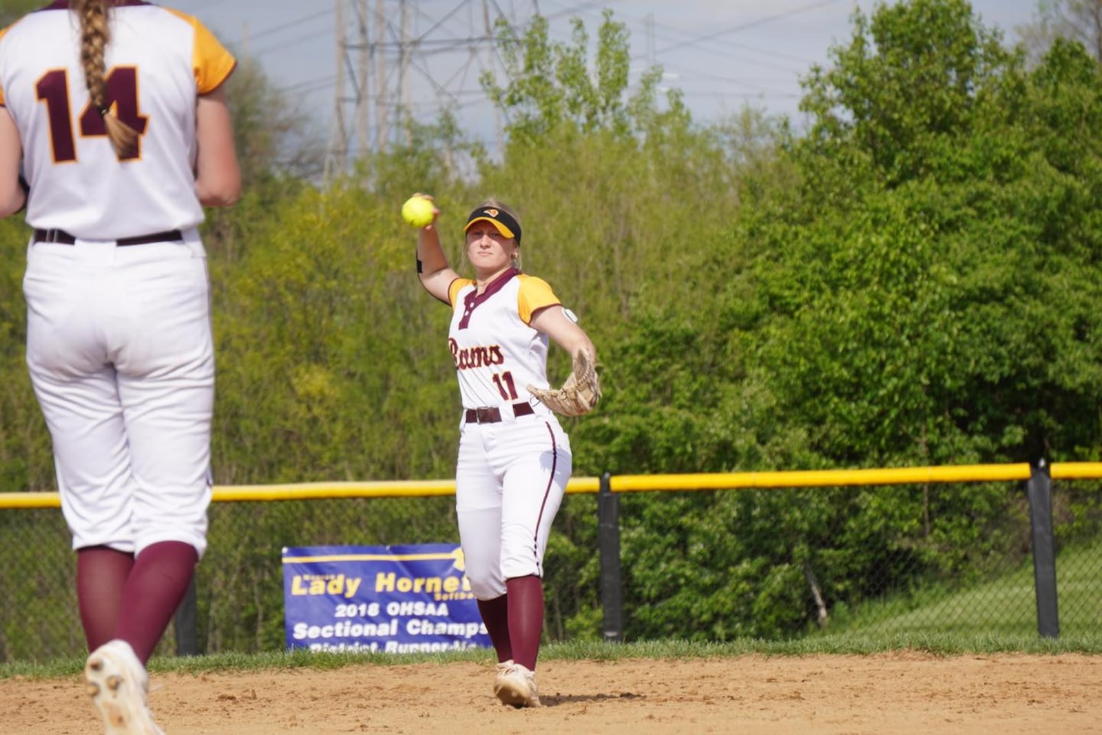 Ross sophomore Paige Baker throws a ball back to pitcher Taylor Bertram during a game against Monroe earlier this season. CHRIS VOGT / CONTRIBUTED