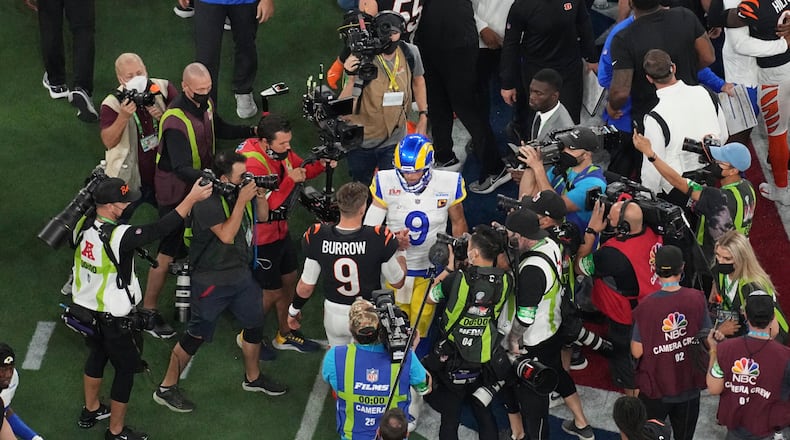 Cincinnati Bengals quarterback Joe Burrow (9) and Los Angeles Rams quarterback Matthew Stafford (9) shake hands at the end of the NFL Super Bowl 56 football game, Sunday, Feb. 13, 2022, in Inglewood, Calif. (AP Photo/Morry Gash)
