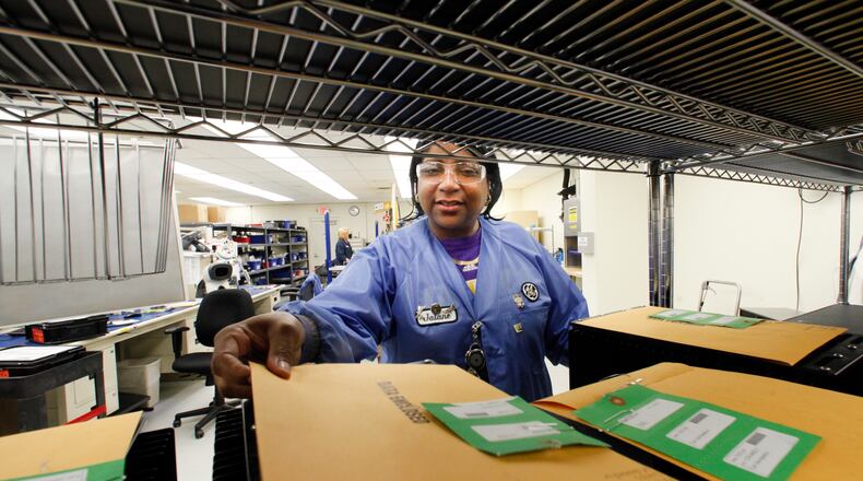 Jalane Cheatham. a quality control inspector at GE Aviation in Vandalia, looks over repaired parts ready for shipment in this 2012 file photo. CHRIS STEWART/STAFF