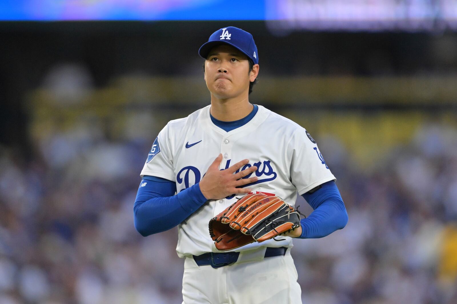 Los Angeles Dodgers pitcher Shohei Ohtani reacts after a base hit by Minnesota Twins' Ryan Jeffers during the third inning of a baseball game in Los Angeles, Monday, July 21, 2025. (AP Photo/Jayne Kamin-Oncea)