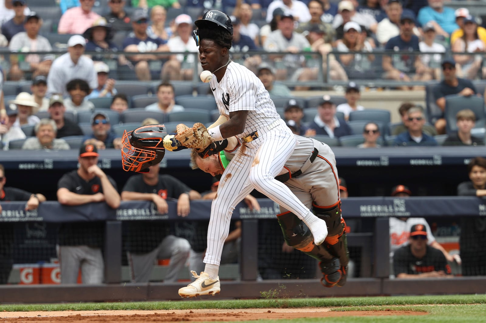 New York Yankees' Jazz Chisholm Jr. collides with Baltimore Orioles catcher Maverick Handley while running to home plate on a single hit by DJ LeMahieu during the second inning of a baseball game Sunday, June 22, 2025, in New York. (AP Photo/Pamela Smith)