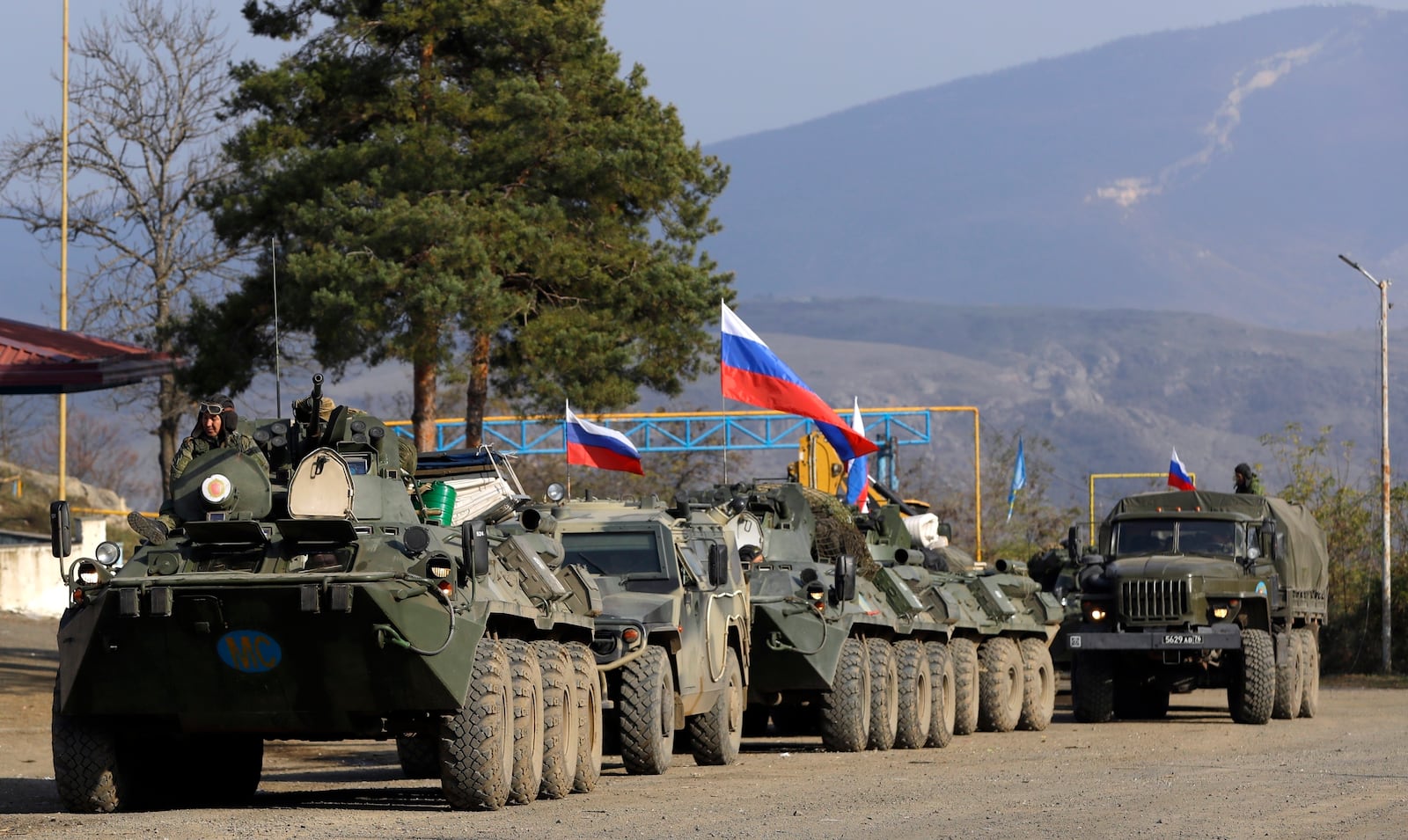 FILE - Vehicles used by Russian peacekeepers are seen parked at a checkpoint on the road in the region of Karabakh in the South Caucasus, Nov. 17, 2020. (AP Photo/Sergei Grits, File)