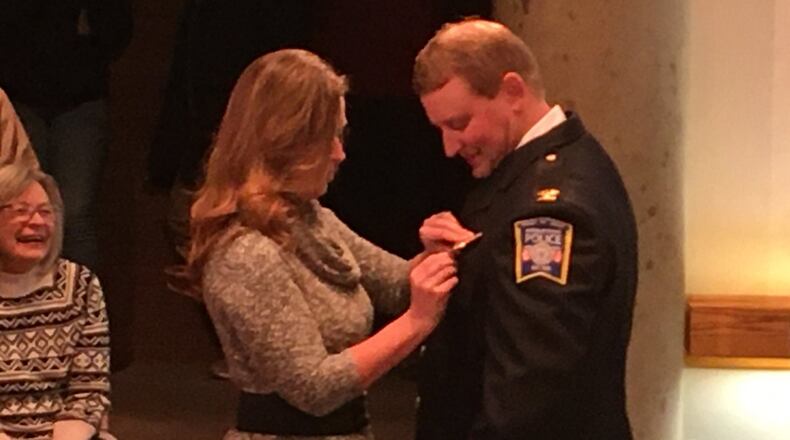 New Middletown police Chief David Birk is pinned with his new badge by his wife Kila during the Jan. 7 meeting of Middletown City Council. The pinning ceremony was witnessed by most of the members of the Division of Police. Acting City Manager Susan Cohen gave an overview of Birk’s record and accomplishments during his tenure with the Division of Police. ED RICHTER/STAFF