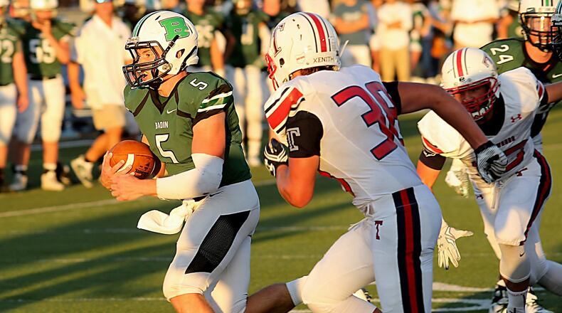 Badin quarterback Andrew Walsh runs past Talawanda’s Sam Wespiser (38) during Saturday night’s game at Virgil Schwarm Stadium in Hamilton. CONTRIBUTED PHOTO BY E.L. HUBBARD
