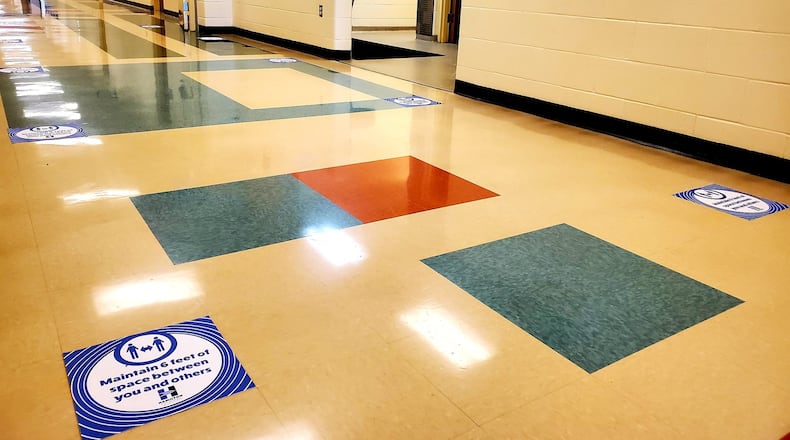 Like many area schools, Hamilton High School is dotted with warning signs regarding coronavirus precautions as students return to the city school district Monday. The impacts of coronavirus safety protocols are deep and widespread, say local school officials. (Provided Photo\Journal-News)