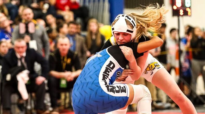 Sidney s Josie Davis (white singlet) won the 126-pound weight class at the Ohio High School Wrestling Coaches Association girls state wrestling championships Sunday at Hilliard Davidson High School. Kevin Bowyer Photography / Contributed