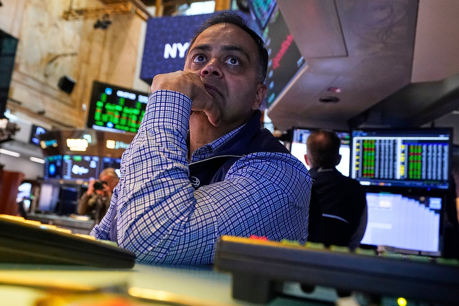 Specialist Dilip Patel works at his post on the floor of the New York Stock Exchange, Monday, April 28, 2025. (AP Photo/Richard Drew)
