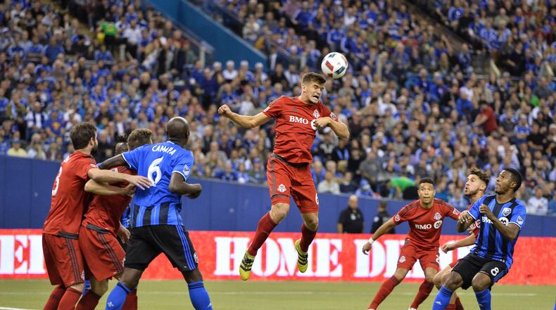 MONTREAL, QC - NOVEMBER 22: Nick Hagglund #6 of the Toronto FC jumps to play the ball during leg one of the MLS Eastern Conference finals against the Montreal Impact at Olympic Stadium on November 22, 2016 in Montreal, Quebec, Canada. (Photo by Minas Panagiotakis/Getty Images)