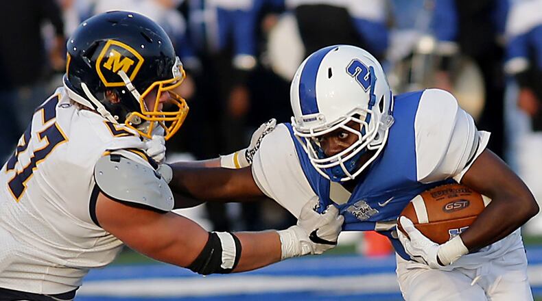 Hamilton’s DaQuan Maffett can’t escape Moeller’s Ryan Mullaney during their Skyline Chili Crosstown Showdown game at Virgil Schwarm Stadium in Hamilton on Aug. 26, 2017. The visiting Crusaders won 42-7. CONTRIBUTED PHOTO BY E.L. HUBBARD