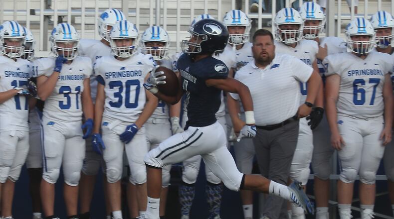 Fairmont's Kamron Payne runs down the side line as carries back the opening kick off for a touchdown in the opening seconds of Friday's game against Springboro. BILL LACKEY/STAFF