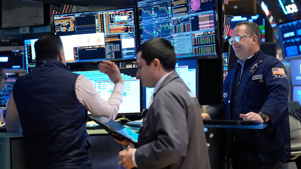 Traders work on the floor at the New York Stock Exchange in New York, Thursday, March 19, 2026. (AP Photo/Seth Wenig)
