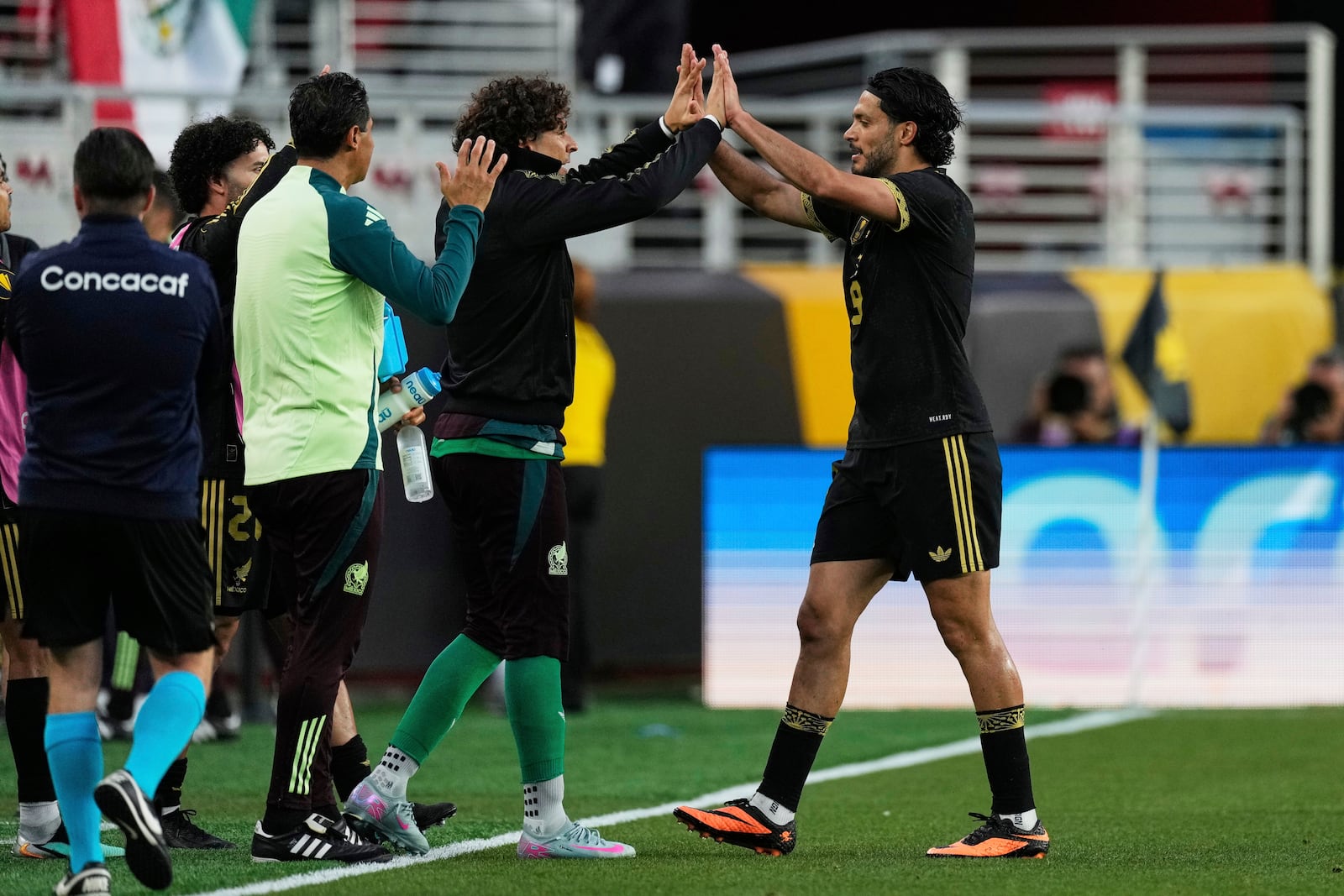 Mexico forward Raúl Jiménez, right, celebrates with teammate Guillermo Ochoa after scoring a goal during the second half of a CONCACAF Gold Cup semifinal soccer match against Honduras, Wednesday, July 2, 2025, in Santa Clara, Calif. (AP Photo/Godofredo A. Vásquez)