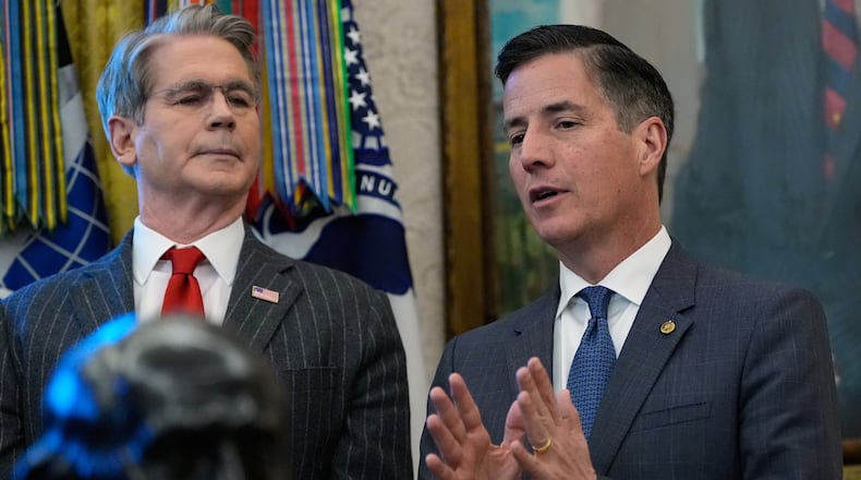 Rep. Bernie Moreno, R-Ohio, speaks during an event with President Donald Trump in the Oval Office of the White House, Monday, Feb. 2, 2026, in Washington, /as Treasury Secretary Scott Bessent listens. (AP Photo/Alex Brandon)