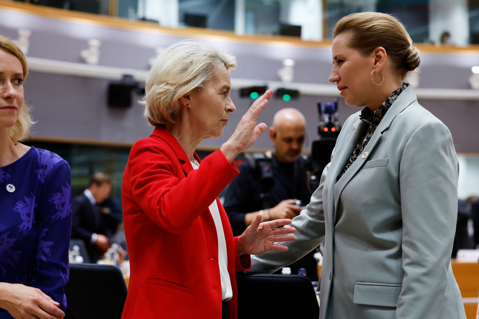 Denmark's Prime Minister Mette Frederiksen, right, speaks with European Commission President Ursula von der Leyen, center, during a round table meeting at an EU summit in Brussels, Thursday, June 26, 2025. (AP Photo/Geert Vanden Wijngaert)