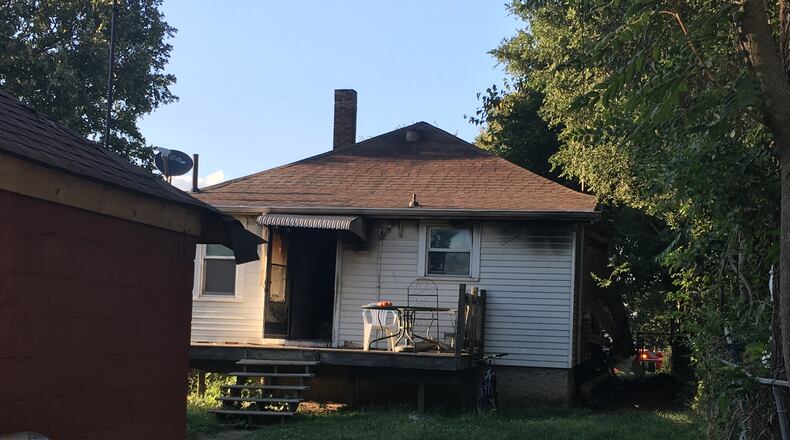 The back of a home in the 1700 block of Taylor Avenue in Middletown. The cause of the fire is still under investigation, but it appears a burning candle caught plastic on the wall on fire, according to the fire department. WAYNE BAKER/STAFF
