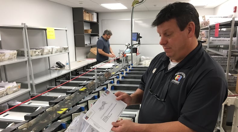 Sometimes absentee ballots arrive without the proper information or a signature. Those are separated out and voters are notified via mail and given a chance to correct the information so their vote can be counted. In this file photo from 2016 Montgomery County Board of Elections Deputy Director Steve Harsman sorts through problem ballots. LYNN HULSEY/staff