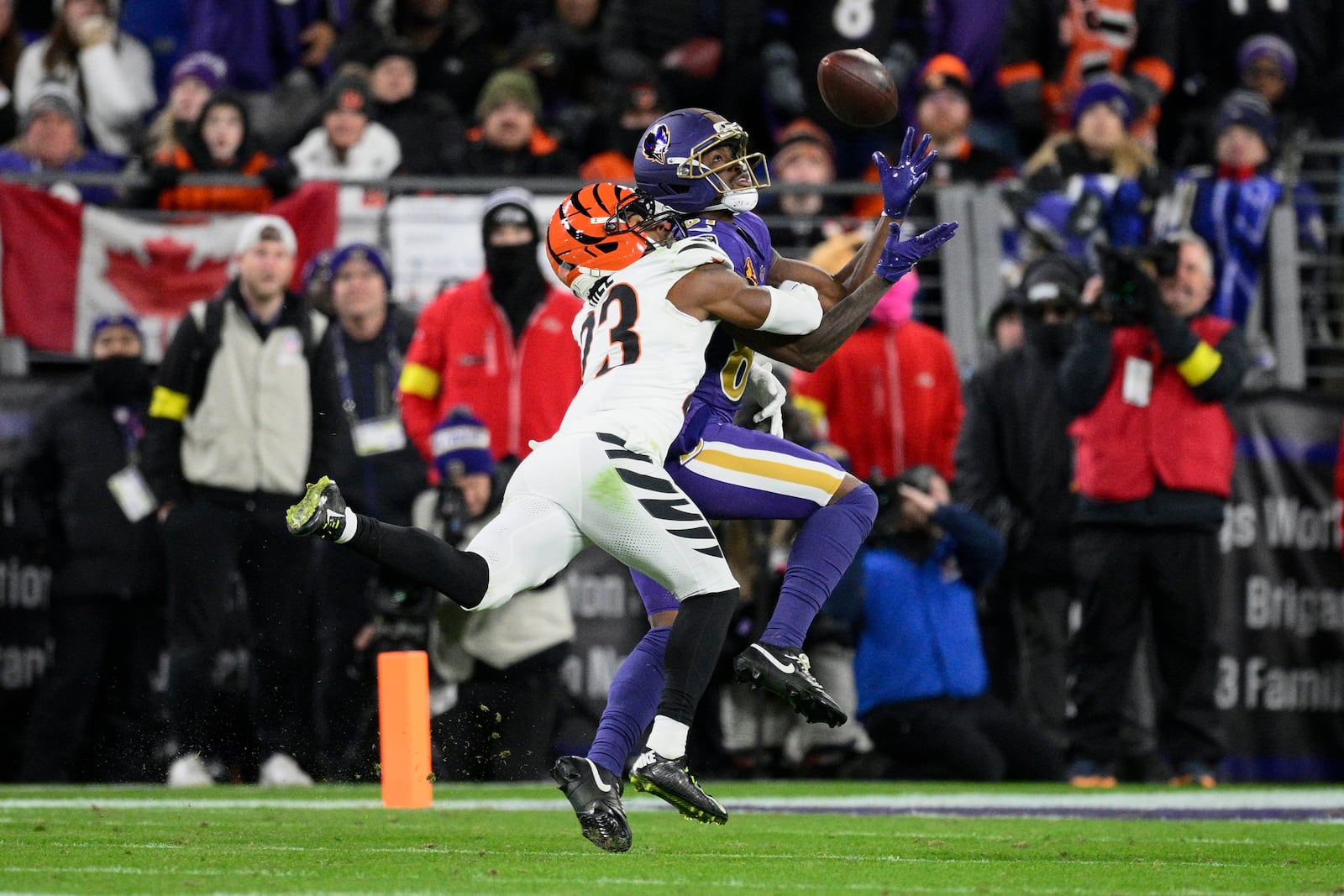 Cincinnati Bengals cornerback Dax Hill, left, breaks up a pass intended for Baltimore Ravens wide receiver Devontez Walker, right, during the second half of an NFL football game, Thursday, Nov. 27, 2025, in Baltimore. (AP Photo/Nick Wass)
