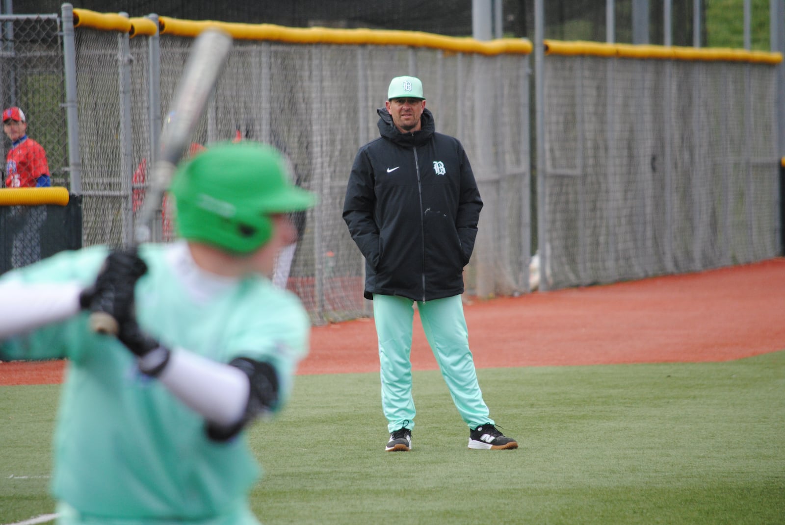 Badin baseball coach Brion Treadway watches on at third base during the Rams' 7-0 loss against Toledo St. Francis de Sales on Friday afternoon at Xenia's Athletes in Action. CHRIS VOGT / CONTRIBUTED