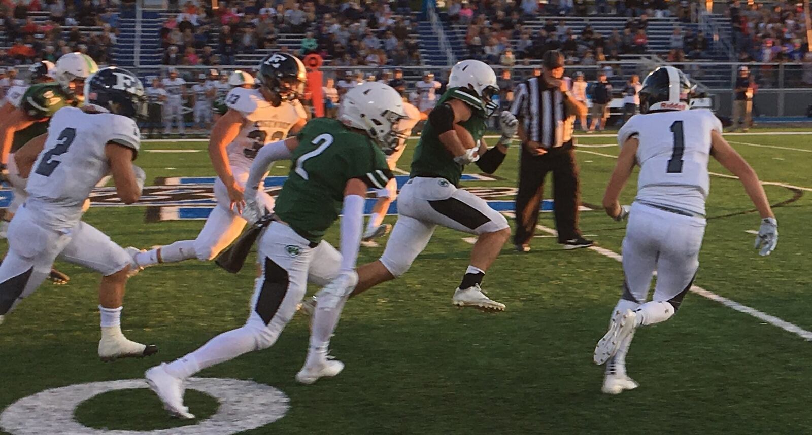 Badin’s Kegen Rogers is chased by Edgewood’s D.J. Whiles (2), Jake Paulsen (33) and Ben Boyd (1) during Saturday night’s game at Virgil Schwarm Stadium in Hamilton. Also trailing is the Rams’ Pat Mignery (2, green). RICK CASSANO/STAFF