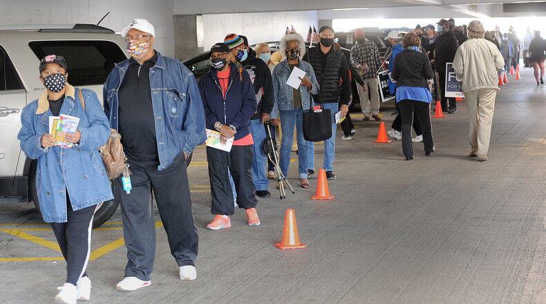 Long lines for early voting at the Montgomery County Board of Elections stretched out into the parking garage Tuesday. MARSHALL GORBY\STAFF