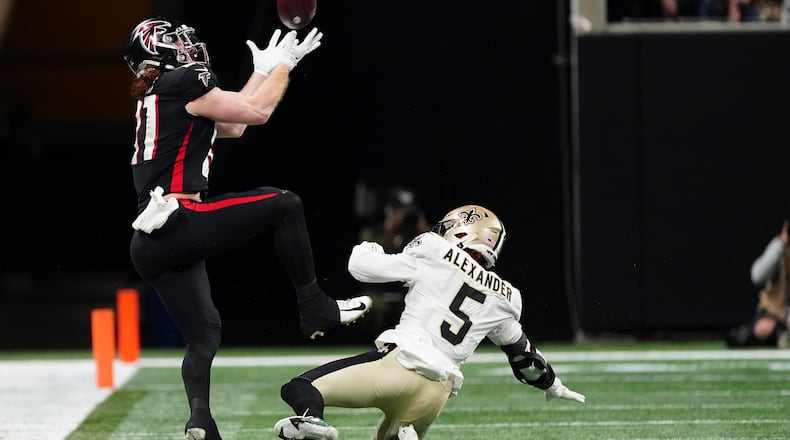 Atlanta Falcons tight end Hayden Hurst (81) makes the catch against New Orleans Saints middle linebacker Kwon Alexander (5) during the second half of an NFL football game, Sunday, Jan. 9, 2022, in Atlanta. (AP Photo/John Bazemore)