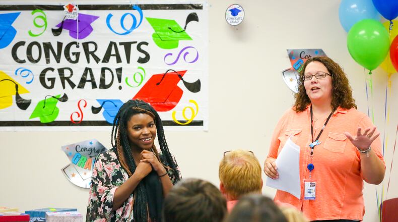 Butler County Children Services Independent Living and Emancipation Coordinator Abby Sexton, right, talks about Trenae, during their annual graduation ceremony for emancipated youth on Thursday, June 25, 2015. Trenae has not only graduated from high school but recently graduated from Miami University. GREG LYNCH / STAFF