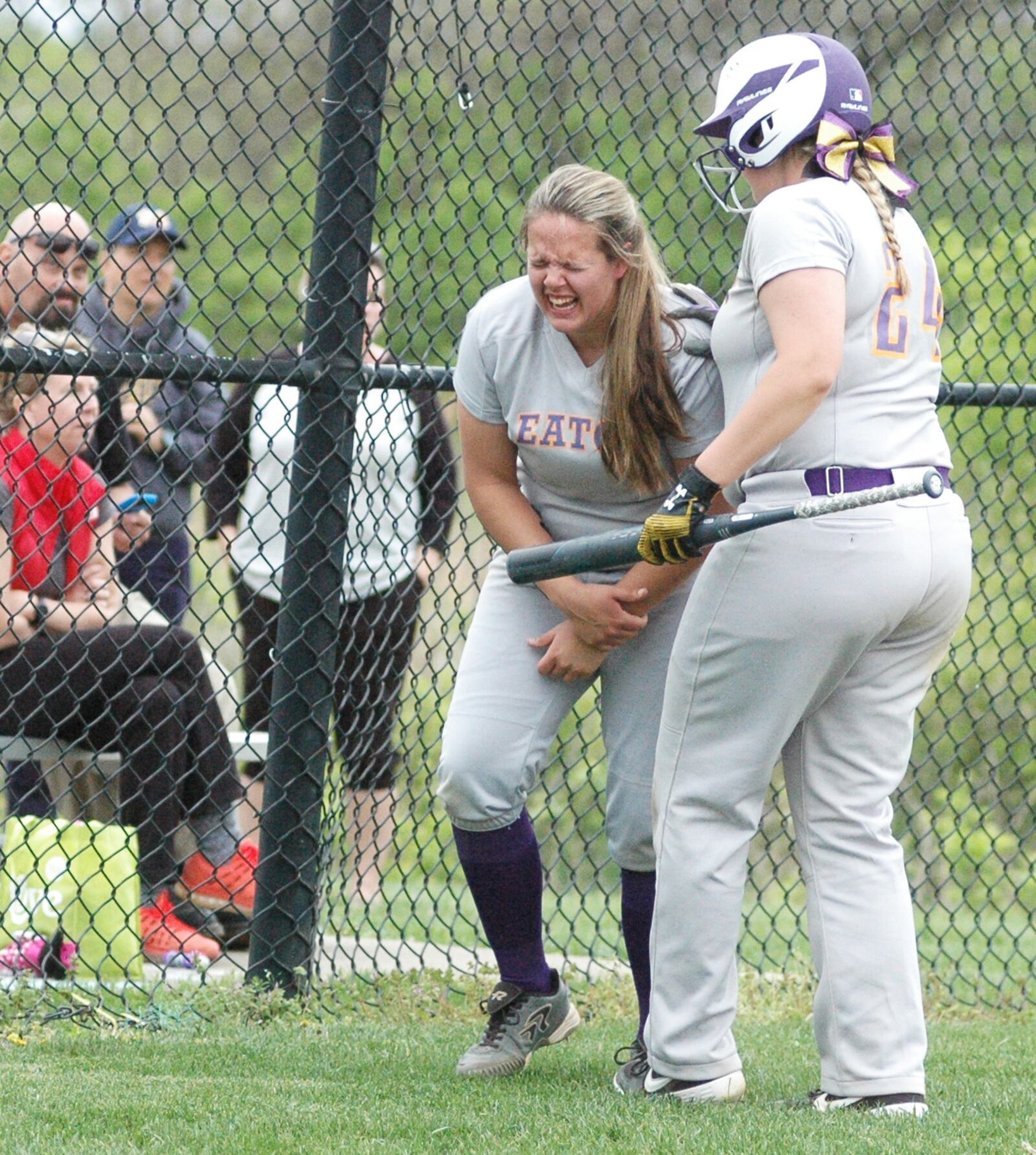 Eaton’s Annika Gels is comforted by teammate Becca Mowen after getting hit by a pitch Wednesday during a Southwestern Buckeye League Southwestern Division softball game at Monroe. Eaton won 5-1. RICK CASSANO/STAFF