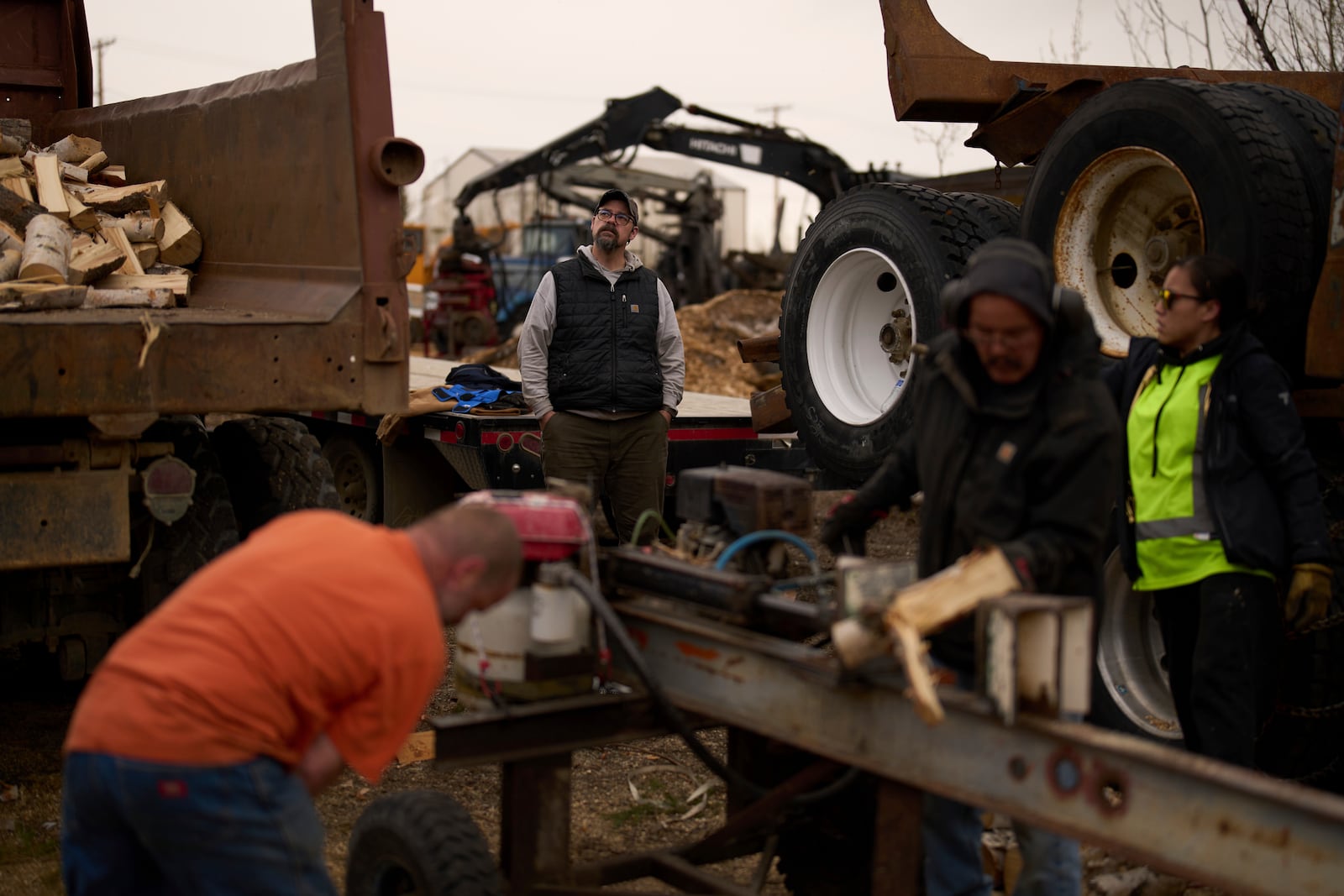 Tim Kalke, general manager of Sustainable Energy for Galena, Alaska, watches as some of his workers split logs Monday, May 19, 2025, in Galena. (AP Photo/John Locher)