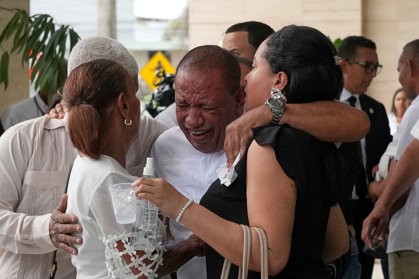 Family members mourn during the memorial of Octavio Dotel, a former MLB baseball player who died at the Jet Set nightclub where more than 200 people were killed when its roof collapsed, in Santo Domingo, Dominican Republic, Thursday, April 10, 2025. (AP Photo/Matias Delacroix)